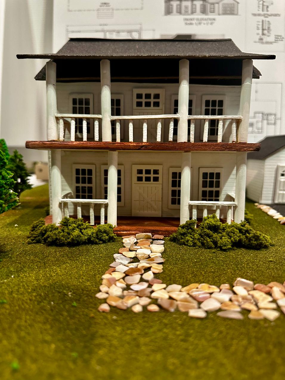 Colonial Greek Revival 1/4-scale home model, front elevation with columned porch, turned balusters, and flagstone walkway