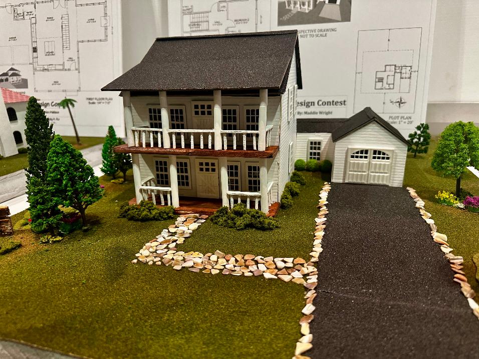 Colonial Greek Revival model three-quarter view showing garage and presentation board